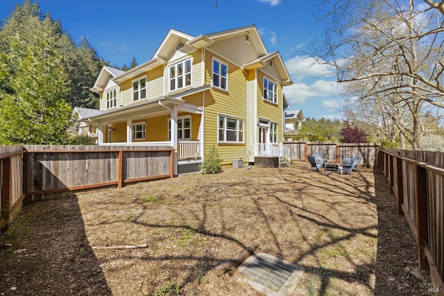 back of house with a fenced backyard