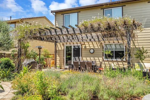 back of house with a pergola and outdoor lounge area