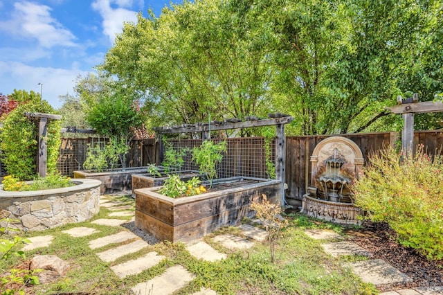 view of yard with fence and a garden