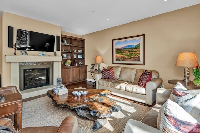 living area featuring a high end fireplace, recessed lighting, and wood finished floors