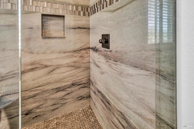 full bath featuring a marble finish shower