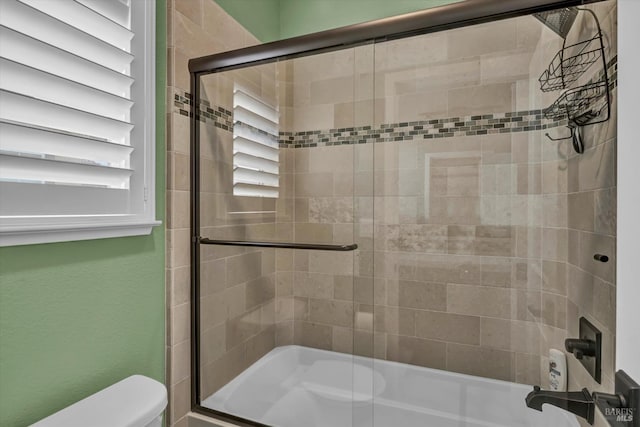 bathroom with toilet and enclosed tub / shower combo
