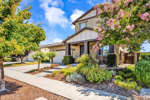 view of front of house with concrete driveway and an attached garage