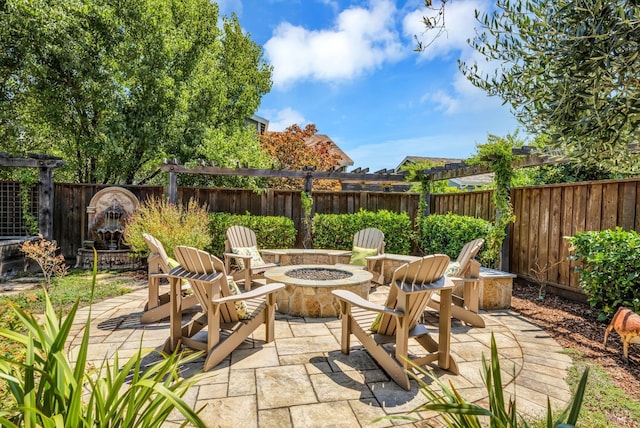 view of patio featuring a fenced backyard and a fire pit