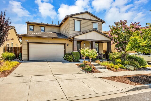 218 Saffron Ct, Napa, CA 94559 - view of front of home with a porch, concrete driveway, fence, an attached garage, and board and batten siding