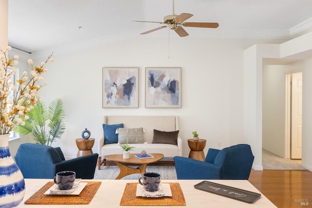 living area featuring wood finished floors, lofted ceiling, and ceiling fan
