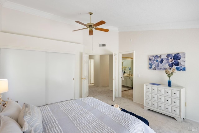 bedroom featuring high vaulted ceiling, crown molding, a closet, light carpet, and visible vents