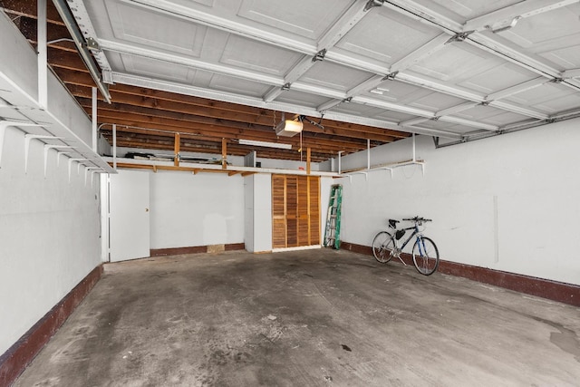 garage featuring baseboards and a garage door opener