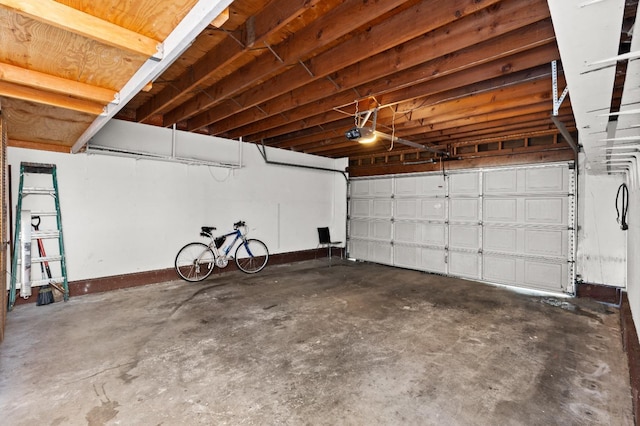 garage with baseboards and a garage door opener
