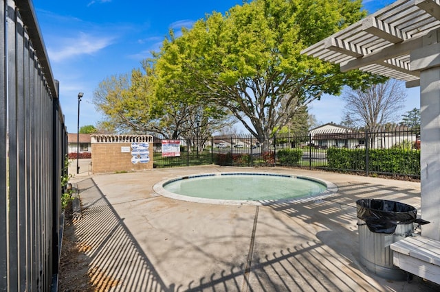 view of swimming pool with fence and a pergola