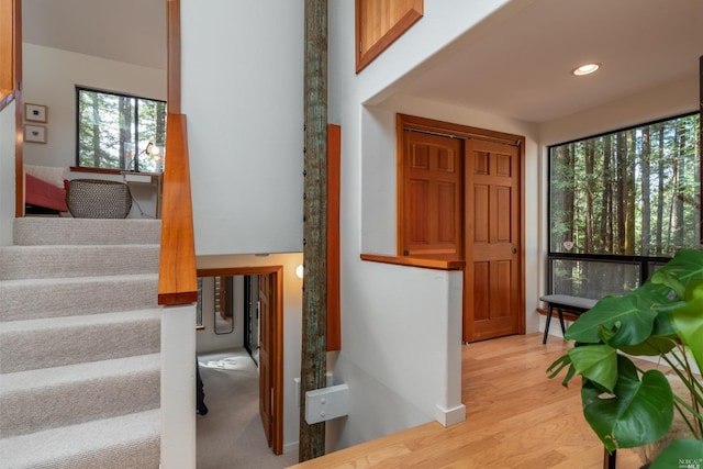 interior space featuring stairs, light wood-type flooring, and recessed lighting