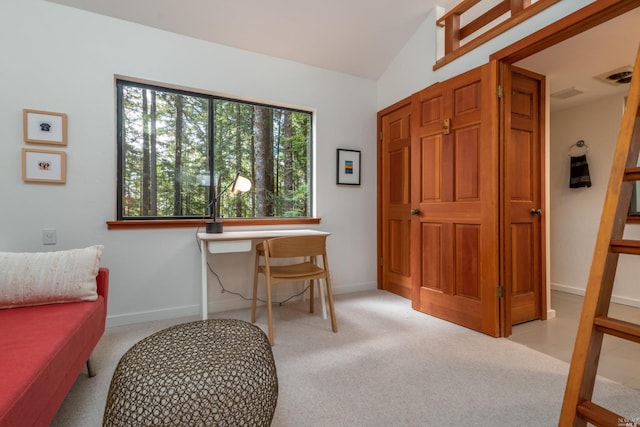 home office featuring light carpet, baseboards, visible vents, and lofted ceiling