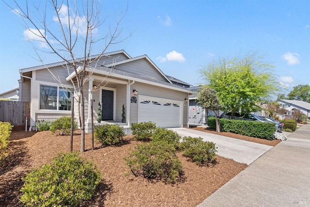 ranch-style house featuring a garage, fence, and concrete driveway