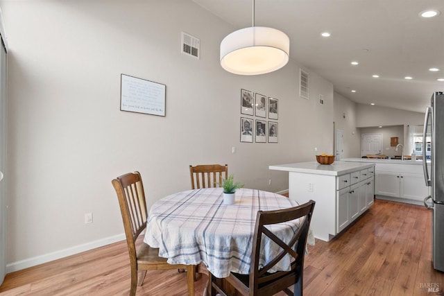 living area featuring recessed lighting, light wood-style flooring, and visible vents