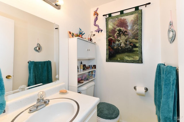 half bathroom with toilet and vanity