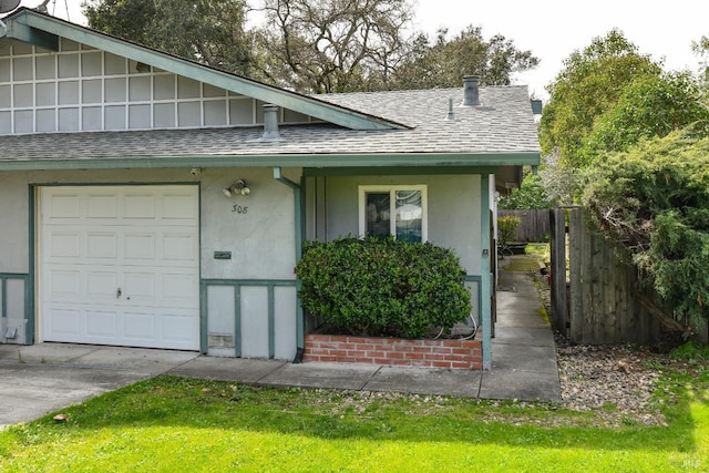 exterior space featuring stucco siding, fence, concrete driveway, and roof with shingles