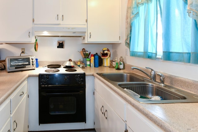 kitchen with light countertops, under cabinet range hood, a sink, white cabinets, and black electric range