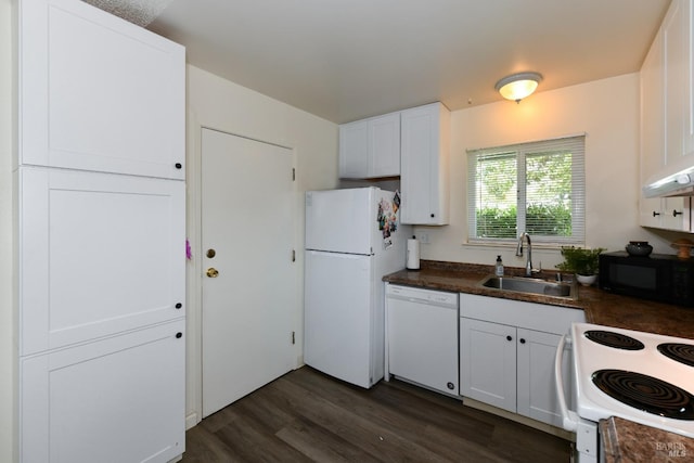 kitchen featuring white appliances, dark wood-style flooring, a sink, dark countertops, and white cabinets