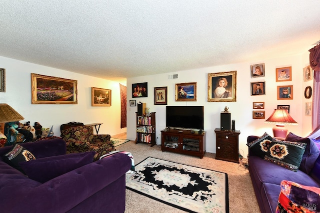 living room with a textured ceiling, visible vents, and light carpet