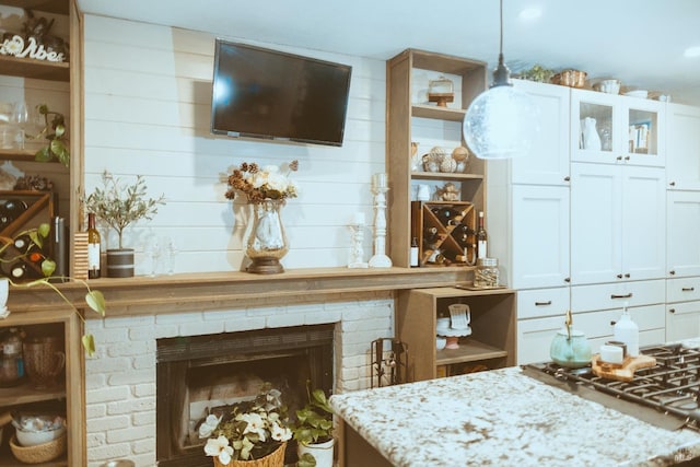 living area featuring a brick fireplace
