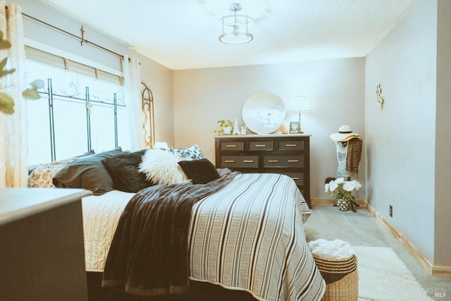 bedroom with carpet flooring and baseboards