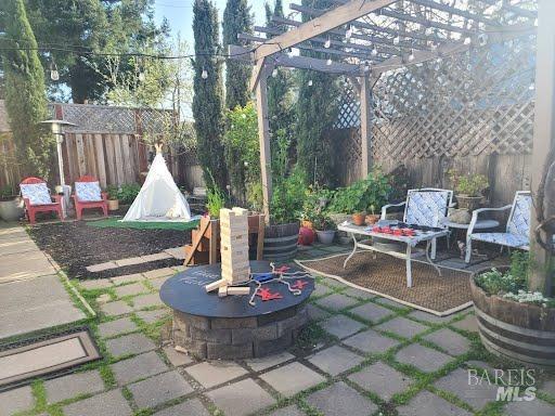 view of patio with a pergola and an outdoor fire pit