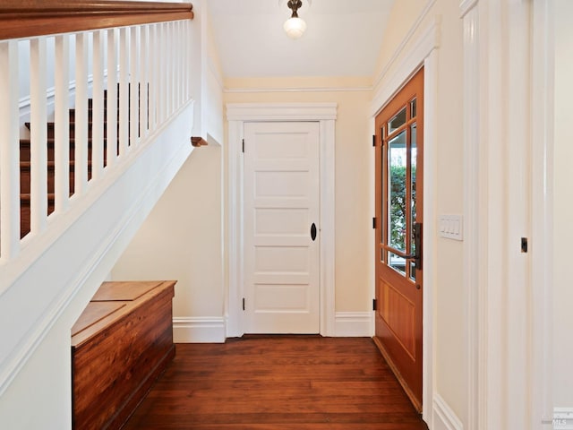 doorway to outside with baseboards and dark wood finished floors