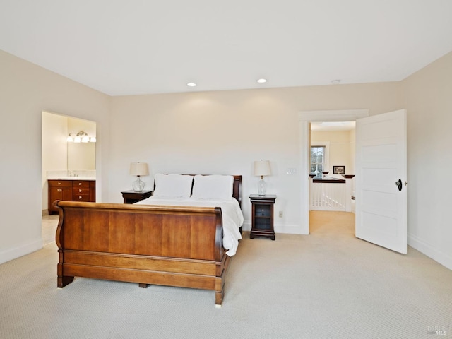 bedroom with connected bathroom, recessed lighting, baseboards, and light carpet