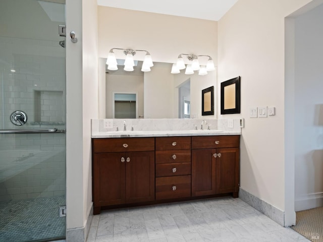 bathroom with double vanity, baseboards, a sink, and a stall shower