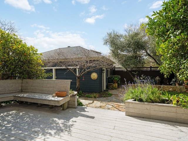 wooden terrace featuring a fenced backyard