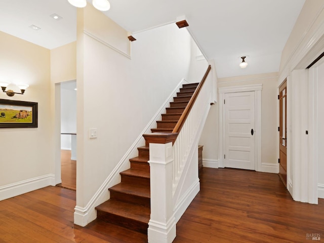 stairs featuring baseboards and wood finished floors