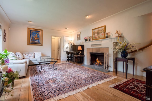 living room featuring hardwood / wood-style floors and a tiled fireplace