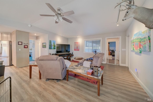 living room with light wood-style floors, baseboards, a ceiling fan, and lofted ceiling