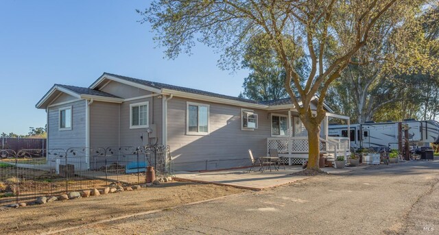 ranch-style home with fence and a patio