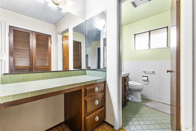 2062 Woolsey Rd, Fulton, CA 95439 - bathroom featuring visible vents, toilet, tile walls, vanity, and wainscoting