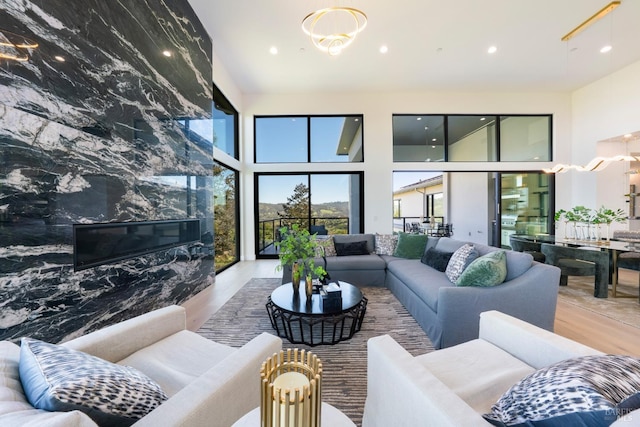 living room featuring an inviting chandelier, recessed lighting, and wood finished floors
