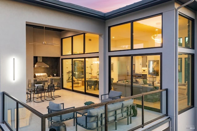 back of property at dusk with stucco siding