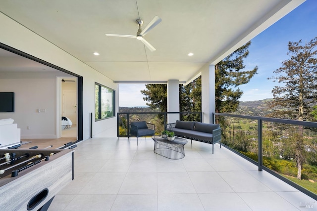 view of patio with a balcony and ceiling fan