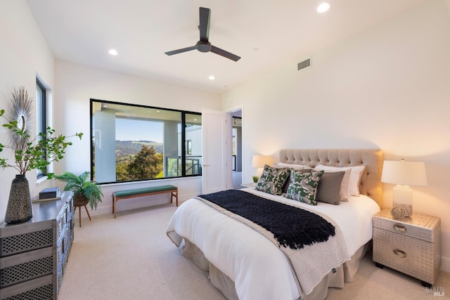 bedroom featuring a ceiling fan, light carpet, baseboards, visible vents, and recessed lighting