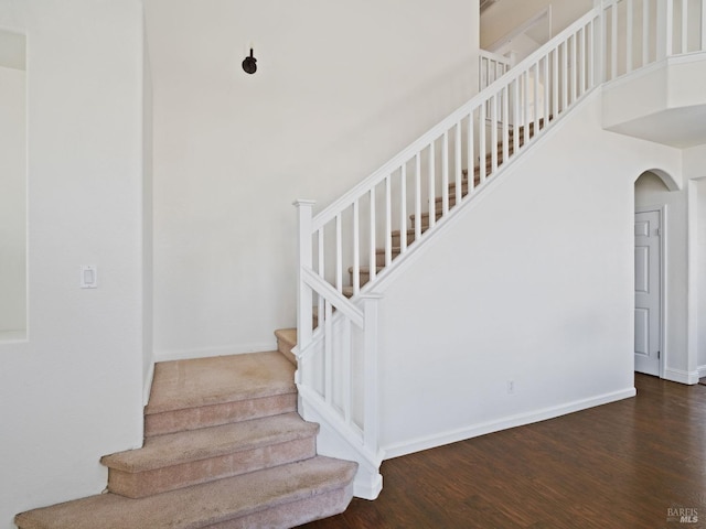 2085 Banjo Dr, Santa Rosa, CA 95407 - stairs featuring a towering ceiling, arched walkways, baseboards, and wood finished floors