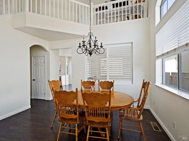 2085 Banjo Dr, Santa Rosa, CA 95407 - dining room with wood finished floors, baseboards, arched walkways, a towering ceiling, and an inviting chandelier