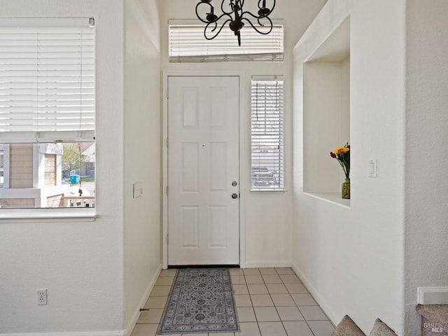 2085 Banjo Dr, Santa Rosa, CA 95407 - entryway with light tile patterned floors, a wealth of natural light, baseboards, and a notable chandelier