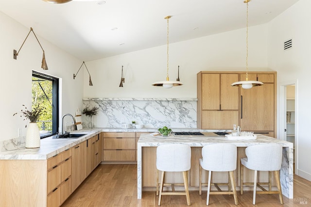 559 E Spring St, Napa, CA 94559 - kitchen featuring light brown cabinets, a sink, modern cabinets, backsplash, and light wood-style flooring