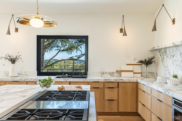 559 E Spring St, Napa, CA 94559 - kitchen featuring light countertops, light wood-style flooring, decorative backsplash, stovetop with downdraft, and a sink