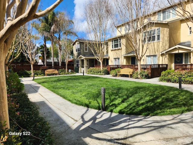 entrance to property with stucco siding and a gate