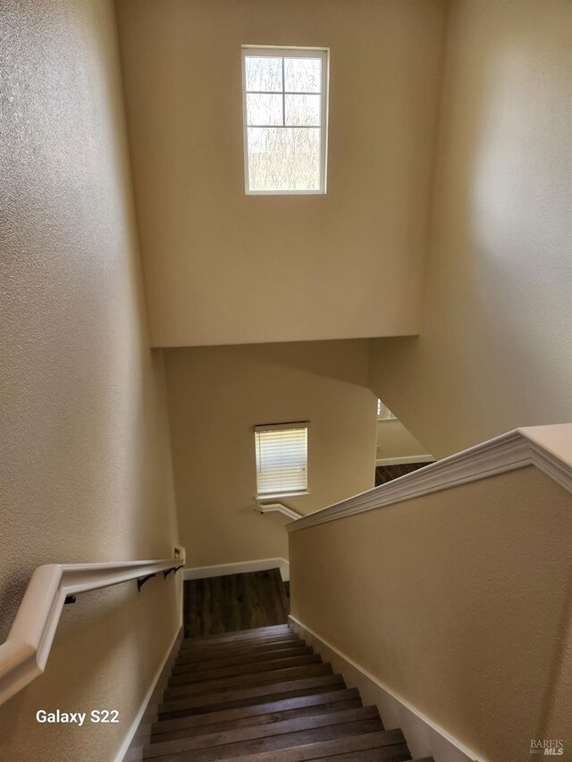 unfurnished bedroom with visible vents, baseboards, and dark wood-style flooring