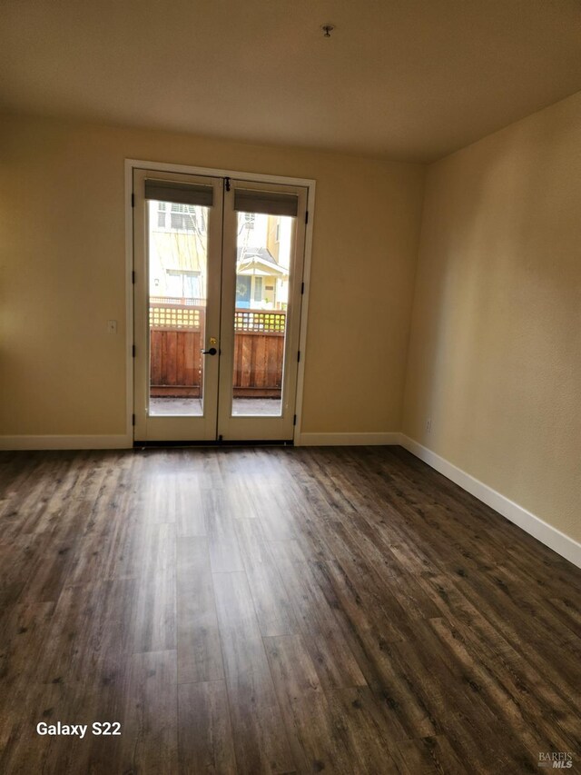 hallway featuring baseboards and wood finished floors