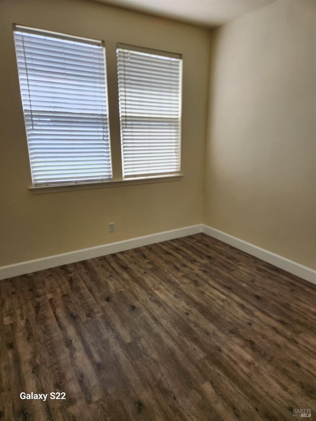 interior space with baseboards, wood finished floors, and stairs