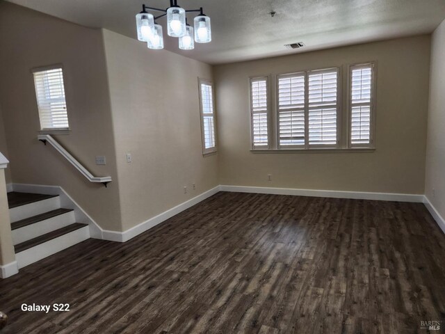 kitchen featuring baseboards, wood finished floors, stainless steel appliances, and a sink