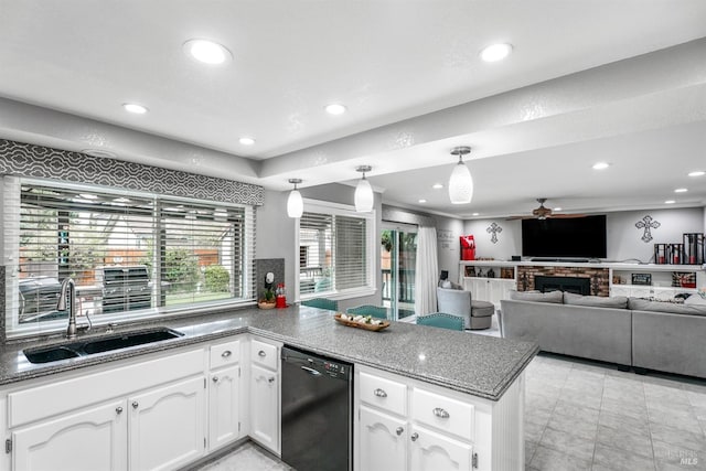 kitchen with white cabinets, a peninsula, dishwasher, a ceiling fan, and a sink